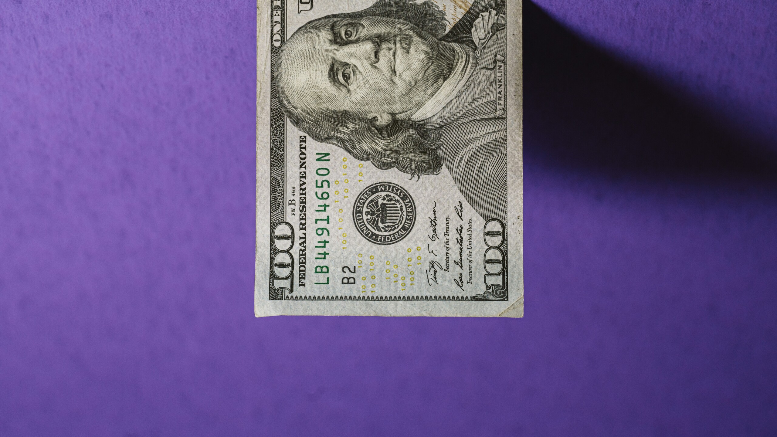 $100 on purple background